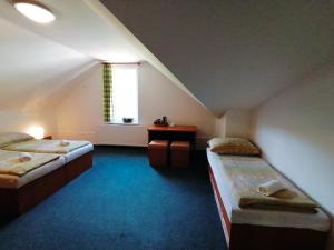 Postel nebo postele na pokoji v ubytování Patriot penzion