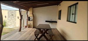 a wooden table sitting on a porch of a house at Espaço Canastra 2 in Delfinópolis