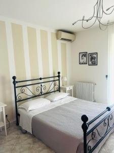 Postel nebo postele na pokoji v ubytování Cà Masawalsa Hotel