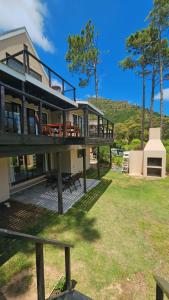 a house with a deck with a table and benches at BestPlaceEver - Luxury House with Vineyard Views in Cape Town