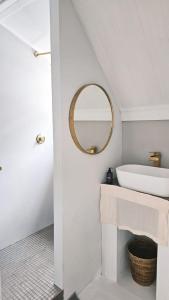 a bathroom with a white sink and a mirror at BestPlaceEver - Luxury House with Vineyard Views in Cape Town