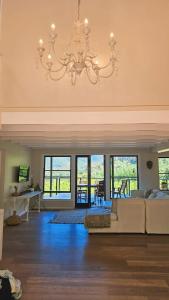 a large living room with a chandelier at BestPlaceEver - Luxury House with Vineyard Views in Cape Town