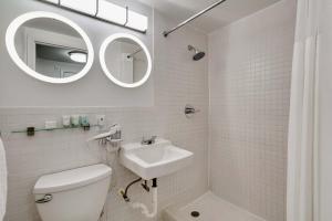 a bathroom with a sink and a toilet and a mirror at Best location by the Beach ! Free WiFi - TV - All amenities 103 in Miami Beach