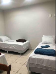Postel nebo postele na pokoji v ubytování Suíte 301 - Pousada no Centro do Rio + 5 fotografií