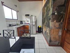 a kitchen with a stainless steel refrigerator and a tile floor at Apartamentos Yaras in Fortuna