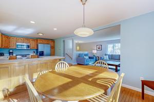 a kitchen and dining room with a wooden table and chairs at Stone’s Throw in Kennebunkport