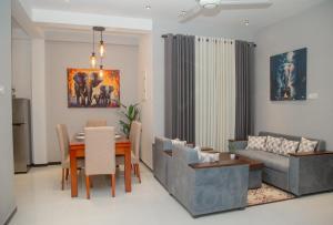 a living room with a table and a couch at Villa White Elephant in Hikkaduwa