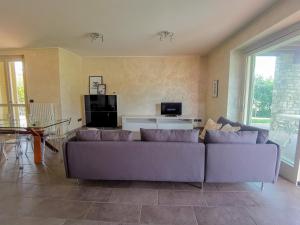 a living room with a couch and a table at Villa Garda Relax in Manerba del Garda