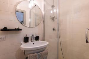 a bathroom with a sink and a mirror at A Casa Lamperini 59 in Rome