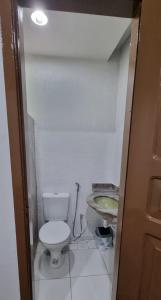 a small bathroom with a toilet and a sink at Suíte 302 - Pousada no Centro do Rio in Rio de Janeiro