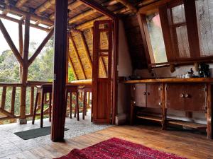 a room with a kitchen with a large window at Glamping Los Nidos in San Augustín