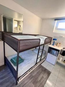 two bunk beds in a room with a mirror at Place à quelques pas du Musée du Louvre au Centre de Paris in Paris +6 photos