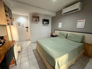 Ένα ή περισσότερα κρεβάτια σε δωμάτιο στο Flat relaxante frente à praia