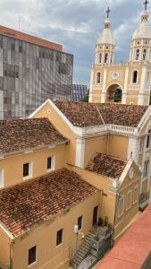 a building with a clock tower and a church at Studio no centro, confortável e prático in Florianópolis