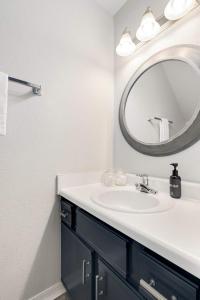 a bathroom with a sink and a mirror at Campus Corner-1 Mi to UofA- 1 Mi to Downtown in Fayetteville +20 photos