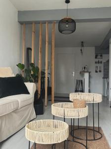 a living room with two tables and a couch at Perigueux T2 proche du quartier historique in Périgueux