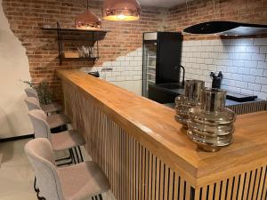 a kitchen with a wooden bar with chairs and a stove at Apartment in Ikast in Ikast
