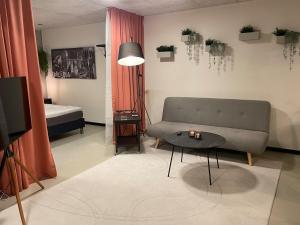 a living room with a couch and a table at Apartment in Ikast in Ikast