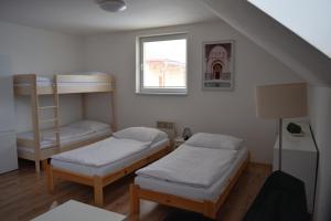 A bed or beds in a room at Penzión na Hranici Čirč