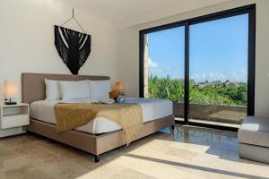 a bedroom with a bed and a large window at Sea Tower by Casago in Playa del Carmen +153 photos