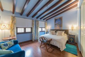 a bedroom with a bed and a couch at El Rey Moro Hotel Boutique in Seville +57 photos