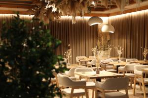 a restaurant with tables and chairs and a christmas tree at Graal resort in Bukovel