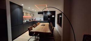 a dining room with a long table and chairs at Apartment in Vichte 1 Bedroom in Anzegem