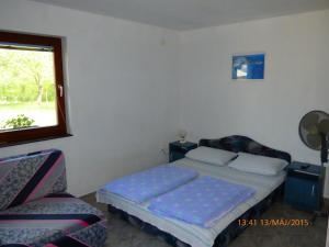 Postel nebo postele na pokoji v ubytování Fábián Apartman-ház