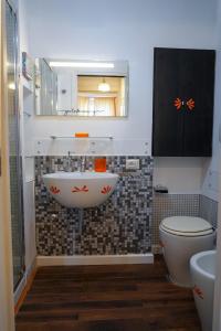 a bathroom with a sink and a toilet at Attico in centro - "La Nica" in Catania