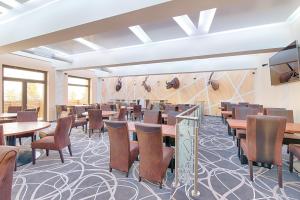 - un restaurant avec des tables et des chaises dans une salle dans l'établissement Hotel Orion, à Abertamy