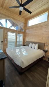 a bedroom with a large bed with a ceiling fan at 061B Grand Canyon South Rim Chalet with King Bed in Valle +10 photos