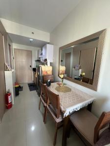 a kitchen and dining room with a table and chairs at MG Place -2 BR condo unit at SMDC Charm Residences, Cainta, Rizal, 1900 in Cainta