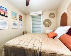 a bedroom with a large bed and a window at Le Chat'Haut Brion in Pessac