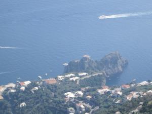 an island in the middle of the water with a boat at Luna D'Agerola in Agerola