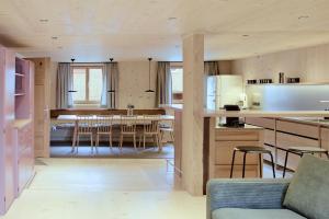 a kitchen and living room with a table and chairs at Ferienhaus Mell Aroma in Mellau