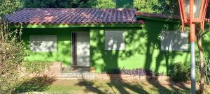 a small green house with a red roof at Casa Icho Cruz in Villa Icho Cruz