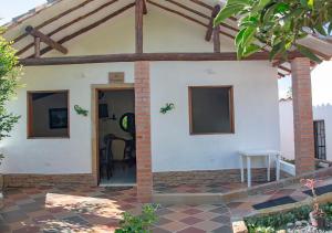 a house with a patio with a door and a table at Mi Terruño in Barichara