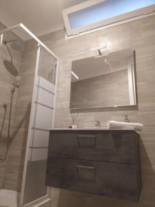 a bathroom with a sink and a mirror and a shower at Le segrete in Sannicandro di Bari