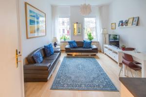 a living room with a couch and a table at Holiday Berlin Apartments in Berlin