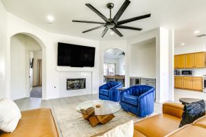 a living room with two blue chairs and a fireplace at 2 Mi to Coachella Indio Oasis with Heated Pool in Indio