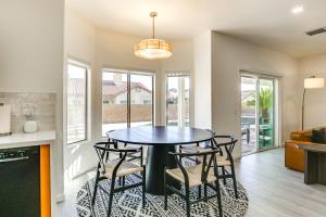 a kitchen and dining room with a table and chairs at 2 Mi to Coachella Indio Oasis with Heated Pool in Indio