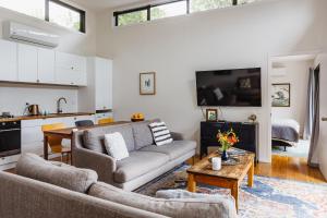 a living room with a couch and a table at Kia Noho in Havelock North
