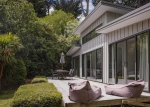 a porch of a house with a table and chairs at Kia Noho in Havelock North