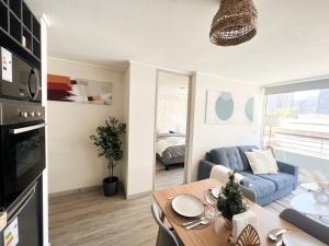 a living room with a blue couch and a table at exclusive apartment with AC and parking in Santiago +25 photos