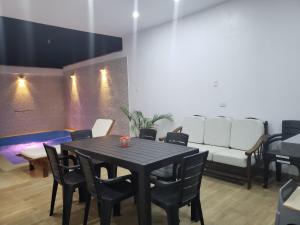 a dining room with a table and chairs and a couch at Hamaka Beach House in Boca del Charán