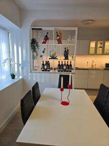 a white table with a candle on it in a kitchen at 4 værelses lejlighed i Vejle in Vejle +10 photos