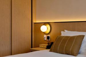 Postel nebo postele na pokoji v ubytování Maxim Hotel - Auckland