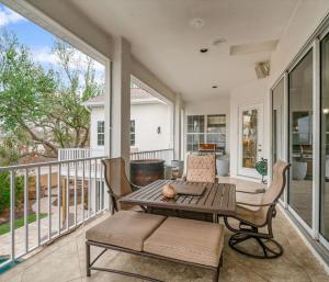 a screened in porch with a table and chairs at Siesta Key Marvel Pool SPA Deeded Beach Access in Sarasota