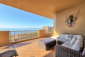 a living room with a couch and an octopus on the wall at Bella Sirena Resort Premium View Condo in Puerto Peñasco