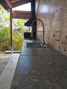 a kitchen with a sink and a counter top at Villa Mantiqueira - Studio I - Com lareira e área verde in Campos do Jordão +27 photos
